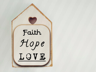 Wall Mural - Inspirational concept - faith, hope, love text written on wooden frame background. Stock photo. 