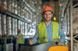 © zinkevych - Warehouse worker in protective helmet smiling positively