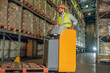 © zinkevych - Warehouse worker in yellow vest working in the warehouse and looking busy