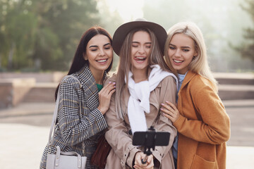 Sticker - Beautiful young women taking selfie outdoors