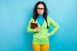 © deagreez - Photo of unhappy angry young woman wear yellow pants hold book homework isolated on shine blue color background