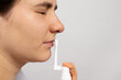 © Zarina Lukash - The patient sprays the nose with allergy spray and rhinitis. Treatment of viral infections, flu, nasal congestion. Banner for medical clinic and pharmacy