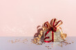 Festively wrapped gift box. Golden paper with ribbon and bow. Holiday Shopping concept