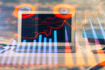 Forex market graph hologram and personal computer on background. Multi exposure. Concept of investment.