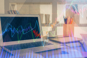 Forex market graph hologram and personal computer on background. Double exposure. Concept of investment.