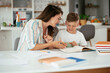 © JustLife - Mother helping her son with homework at home. Little boy learning at home...