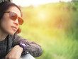 Young asian woman traveler with sun glasses sitting in train, looking through big window. Travel, mountain landscape.