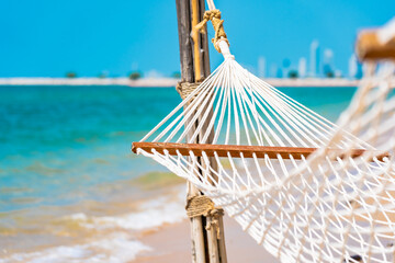 Wall Mural - Empty white hammock around sea beach ocean