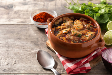 Traditional mondongo or el menudo soup on wooden table.Copy space