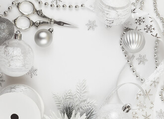 Wall Mural - Christmas silver and white decorations, wrapping ribbons, scissors on white background