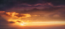 Background Of Cloudscape At The Sunset With Sunshine On Sky And Orange Clouds