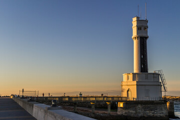 Poster - Harbor on the Basque coast and the lighthouse at sunset