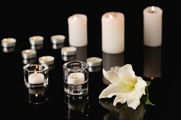 Wall Mural - lily, candles on black background, funeral concept, stock image