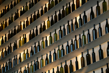 Illuminated bottles in a wine bar on the wall