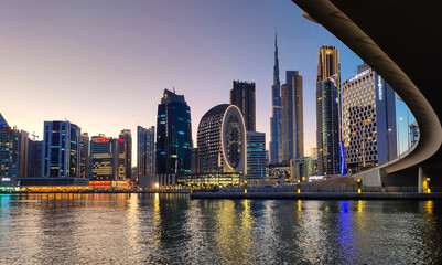 Wall Mural - Downtown Dubai modern cityscape skyline view from the Marasi marina in the Business Bay at sunset in the United Arab Emirates