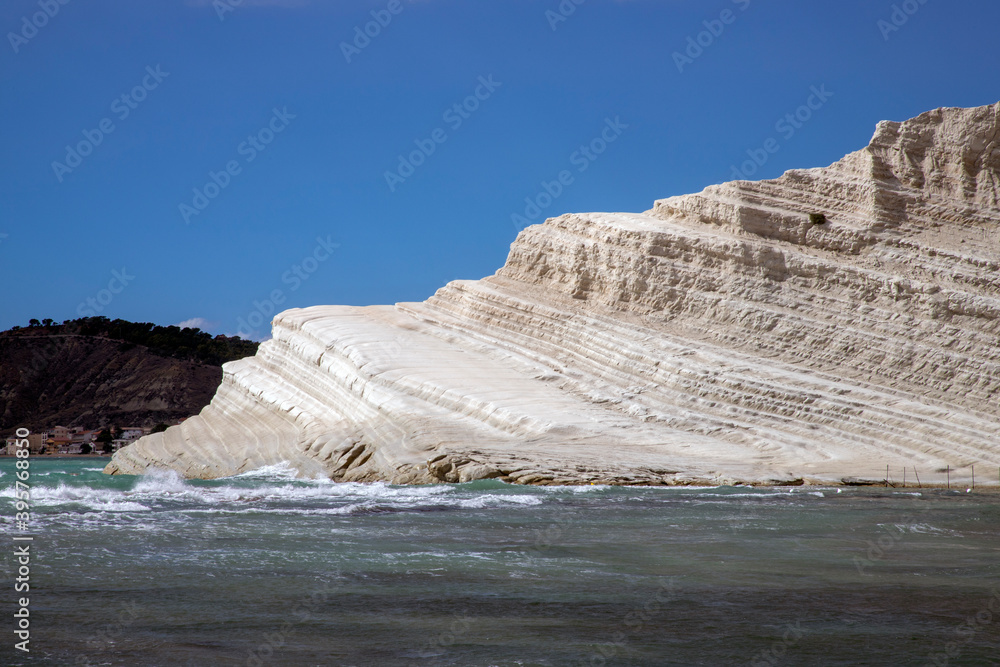 Italian Beaches Rocks View of Rocks and sand beach in front of the white limestone cliffs of ...
