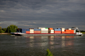 Inlandshipping container vessel transportation containers over the river in the Netherlands Waal River