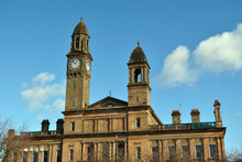 Towers & Clock On Old Victorian Classical Public Building Against Blue Sky