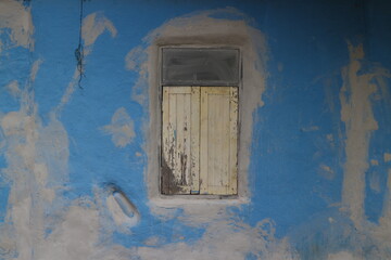 The old window on the blue wall