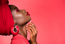 Profile Of African American Woman In Stylish Outfit And Turban With Closed Eyes Isolated On Red