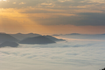 Wall Mural - beautiful sunrise in the carpathian mountains with fog and dramatic sky