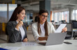 © Red Riding Hood - Two successful women are working on a laptop in the office.