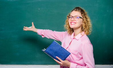 Pedagogue hold book and explaining information. Teacher explain hard topic. Woman school teacher in front of chalkboard. Teacher best friend of learners. Passionate about knowledge. Education concept