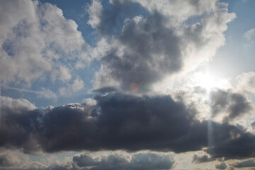 Clouds in blue sky. White, fluffy clouds In blue sky. Background nature. Texture cumulus floating on blue sky. Environment, atmosphere. Place for banner, site an inscription text or logo. Copy space