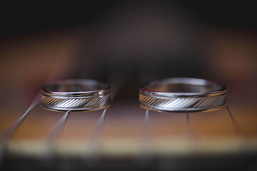 Wall Mural - Closeup of silver wedding rings on strings