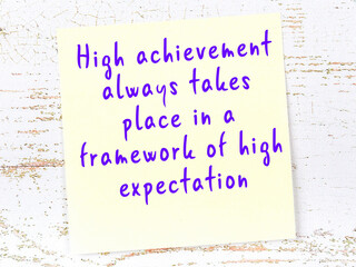 wise quote on sticky note on wooden wall