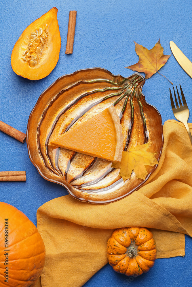 Plate with slice of tasty pumpkin pie on color background
