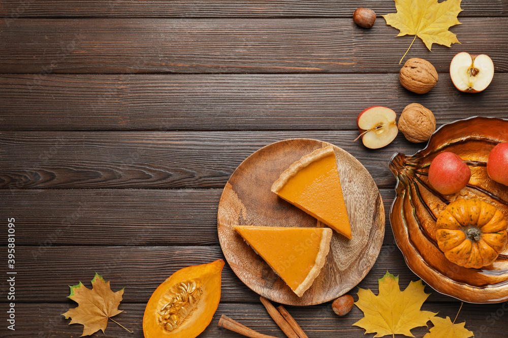 Composition with tasty cut pumpkin pie on wooden background