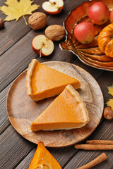 Composition with tasty cut pumpkin pie on wooden background