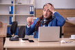 © Elnur - Young sick businessman employee suffering at workplace