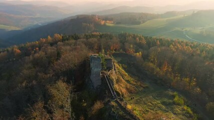 Wall Mural - Aerial drone view of the Zubstejn ruined castle on the hill, Czech Republic. Unidentifiable tourist are climbing to ruindec castle. Autumn weather during sunset.