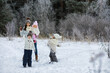 © alexkich - Happy family playing and laughing in winter outdoors in the snow. City park winter day.