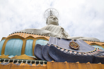 A tall Buddha statue towering.