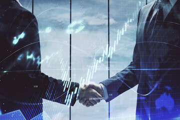 Double exposure of forex graph hologram and handshake of two men. Stock market concept.