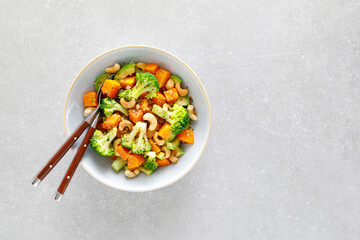 Sticker - Vegetable salad bowl of broccoli, baked pumpkin, avocado and nuts. Healthy vegan food