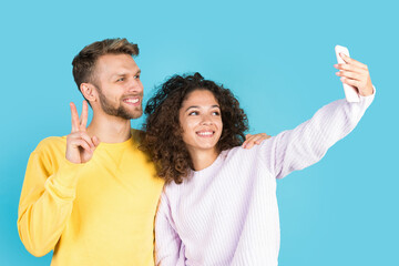 Wall Mural - Afro american woman and european man standing on blue background