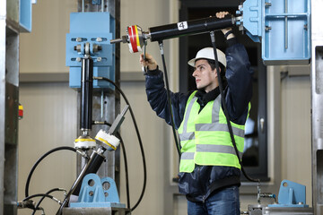 Wall Mural - Portrait of a Caucasian man , factory engineer in work clothes controlling the work process at the helicopter manufacture.