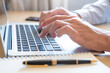© BritCats Studio - Selective focus at Asian men hand while type on computer keyboard and study online learning class at home. Social distance concept new normal lifestyle that people can work  or do home school.