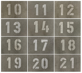 Parking lot numbers in an underground car park sprayed onto the concrete floor with a template.