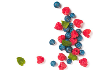 Wall Mural - Various fresh summer berries background with copy space for text.Creative layout of fresh blueberries, raspberries and mint leaves, isolated on white background with clipping path.Top view or flat lay