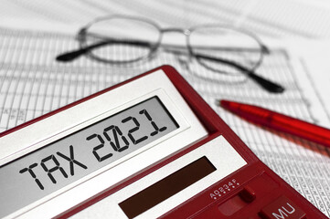 Wall Mural - Word Tax 2021 on calculator. Glasses, pen and the calculator on documents. The concept of financial stability,Income Statement