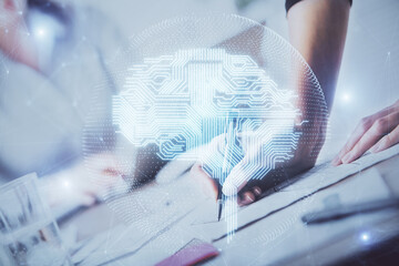 Double exposure of woman's writing hand on background with brain hud. Concept of learning.