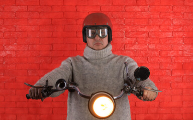 Poster - studio portrait of a male motorcyclist on a red background