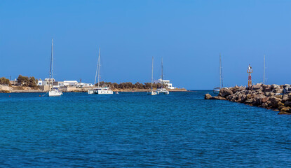 Wall Mural - The view towards the harbour entrance at Vlychada in Santorini in summertime
