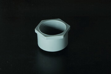 A white round female threaded PVC end cap