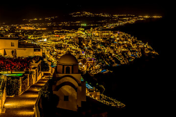 Wall Mural - A view at night looking down over the settlement of Thira, Santorini in summertime